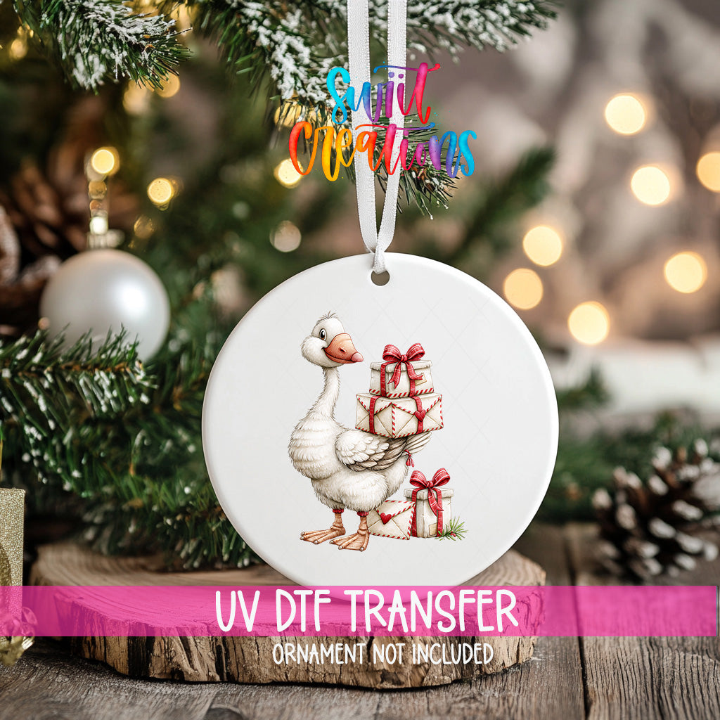 Christmas goose ornament UV DTF transfer carrying cream gifts tied with red bows, mockup view 2