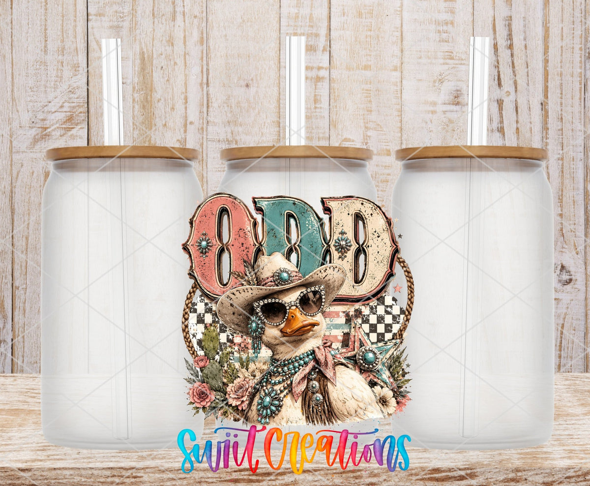 Odd Duck Western Glam UV DTF transfer applied to a clear glass can set from Swiit Creations