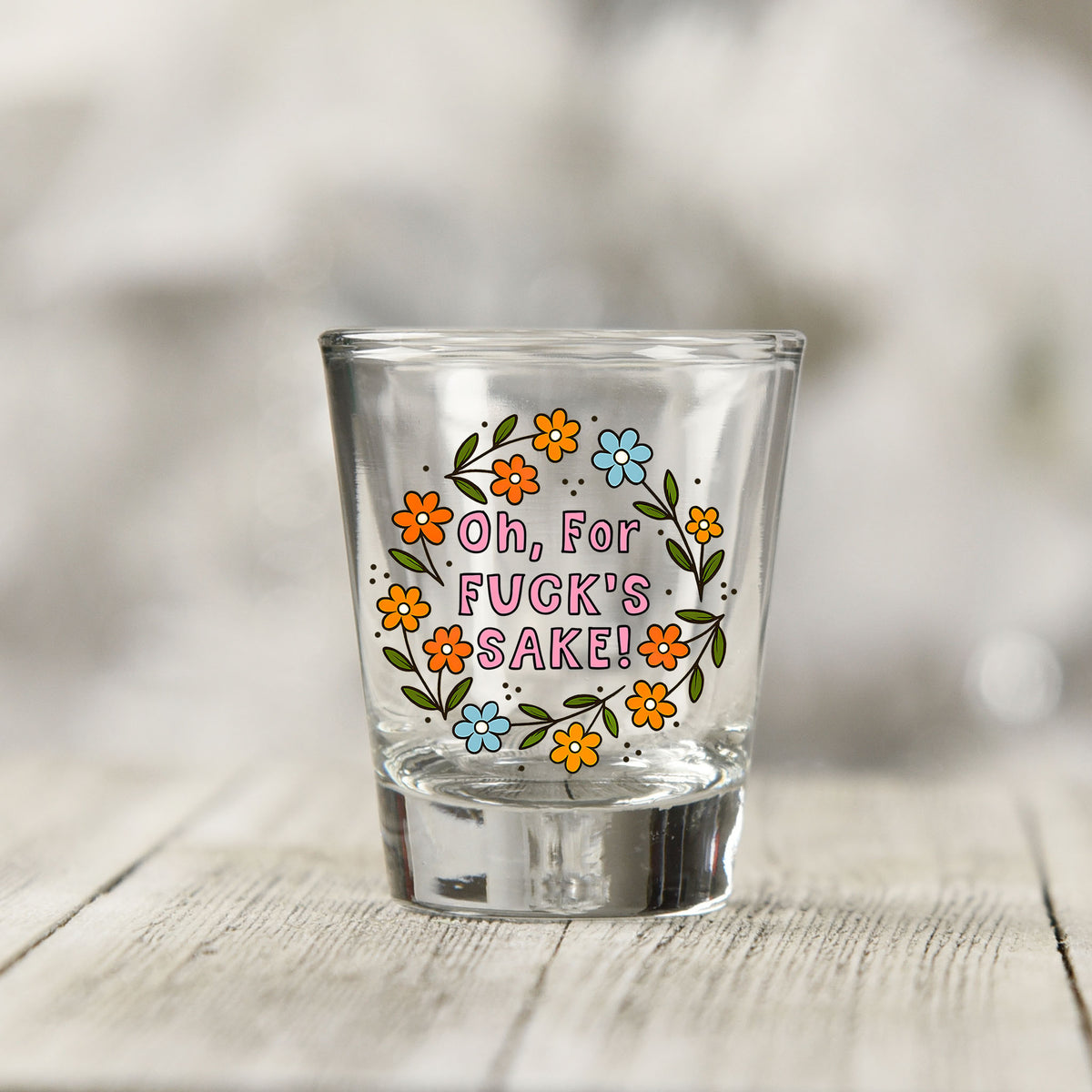 Close-up of the Oh For Fuck's Sake Floral UV DTF transfer on a clear shot glass