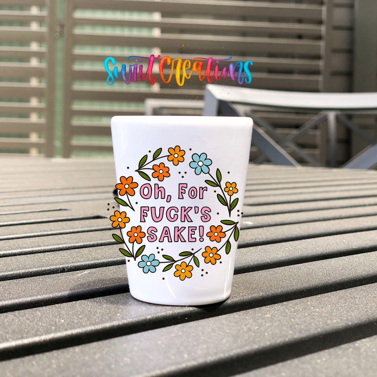 Oh For Fuck's Sake Floral UV DTF transfer on a white shot glass on an outdoor patio table