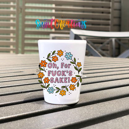 Oh For Fuck's Sake Floral UV DTF transfer on a white shot glass on an outdoor patio table