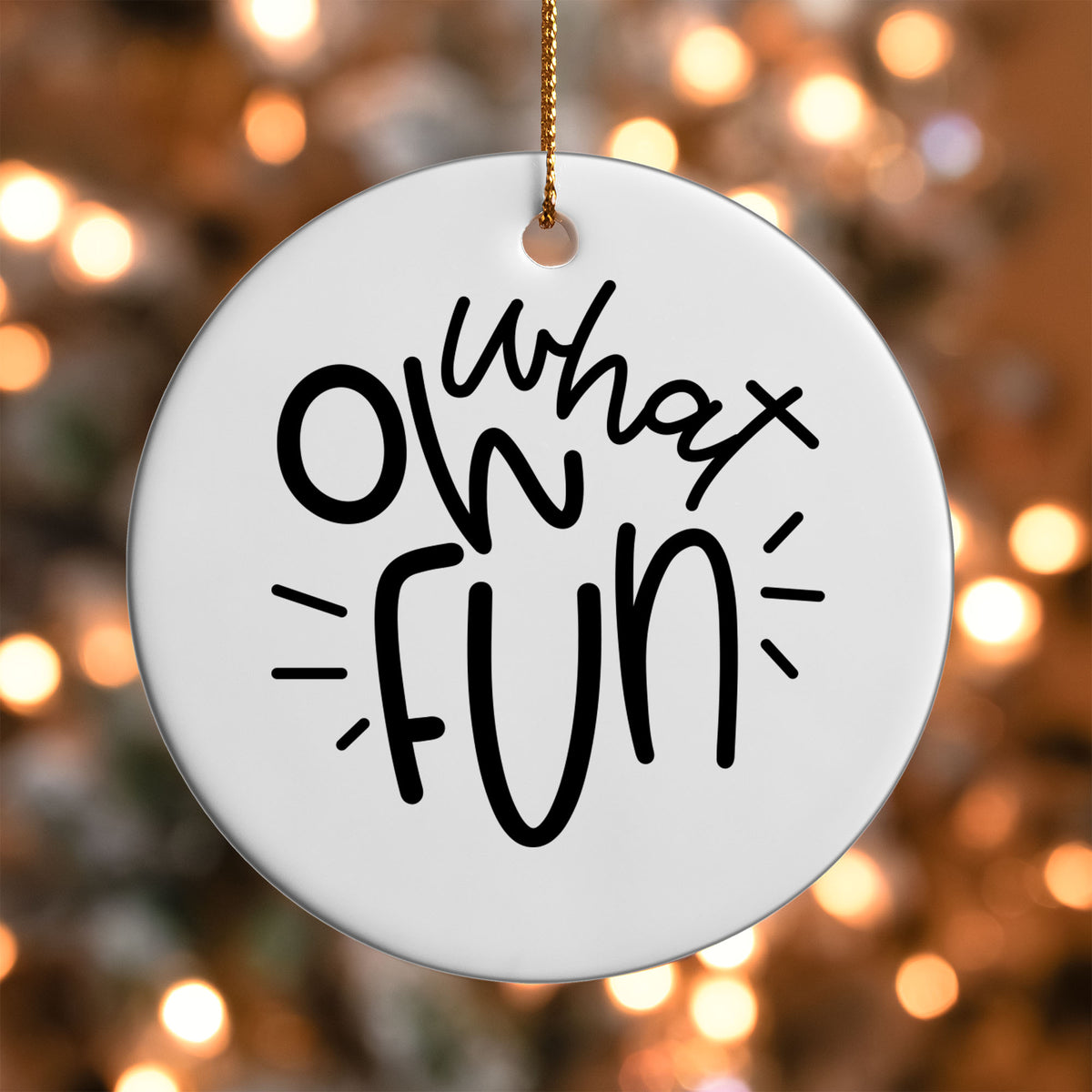 Oh What Fun ornament UV DTF transfer on a round white ornament with a bokeh light background