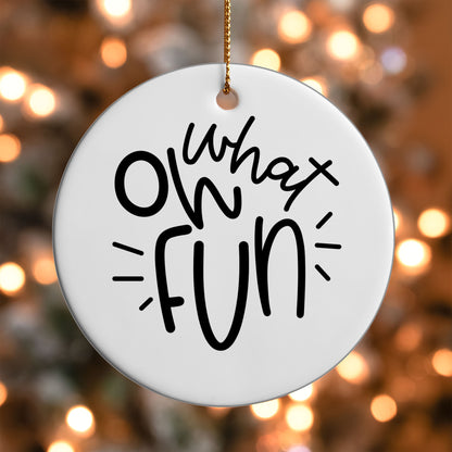 Oh What Fun ornament UV DTF transfer on a round white ornament with a bokeh light background