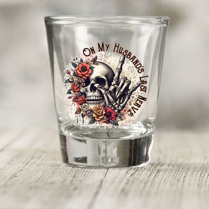 On My Husband's Last Nerve shot glass UV DTF transfer with skull, skeleton hand, and roses on a clear shot glass