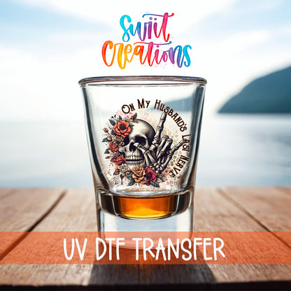 On My Husband's Last Nerve shot glass UV DTF transfer on a filled shot glass on a dock by the water