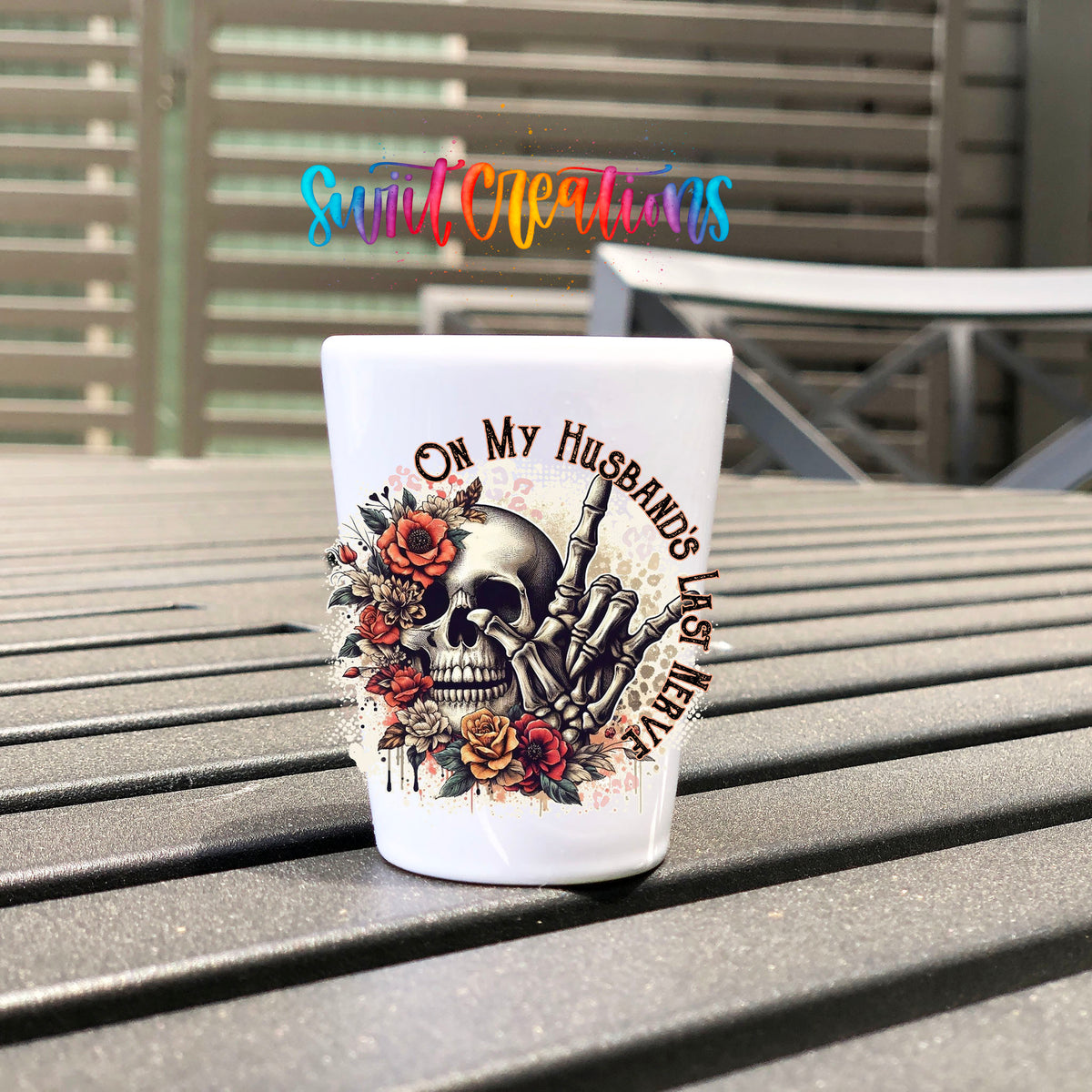 On My Husband's Last Nerve UV DTF transfer on a white shot glass on an outdoor patio table