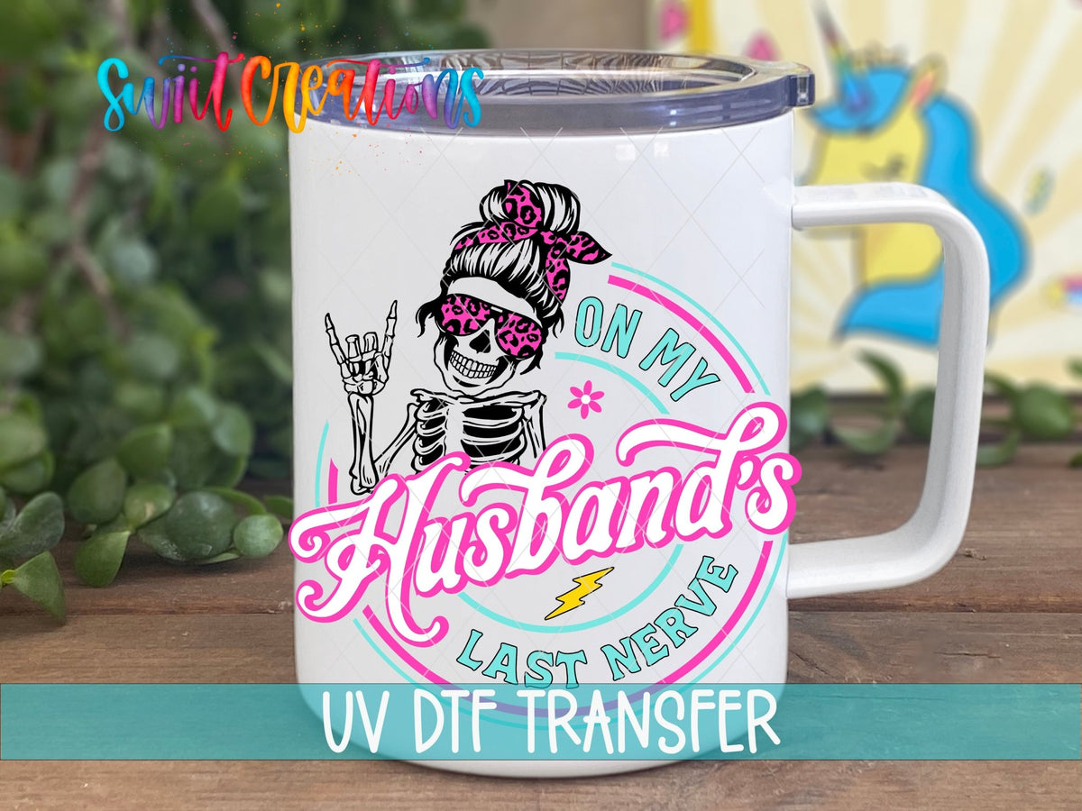 On My Husband's Last Nerve pink messy bun skeleton UV DTF transfer on a white stainless steel mug with a lid