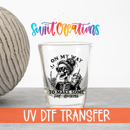 On My Way to Make Bad Decisions UV DTF transfer on a clear shot glass with the Swiit Creations logo and UV DTF Transfer banner