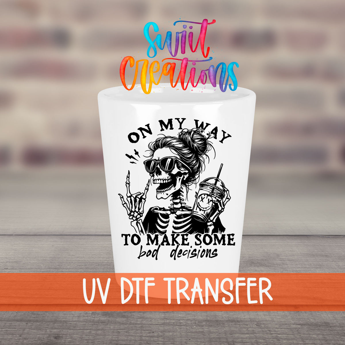 On My Way to Make Bad Decisions UV DTF transfer on a white shot glass in front of a brick wall