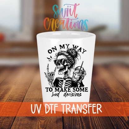 On My Way to Make Bad Decisions shot glass transfer on a white shot glass on a wooden table