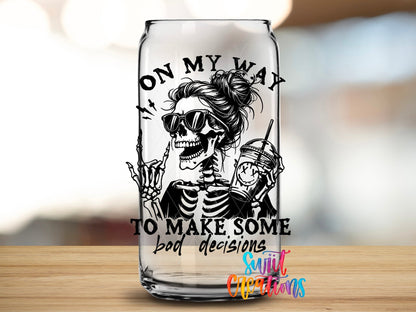 Close-up of the On My Way to Make Some Bad Decisions UV DTF transfer on a clear glass can