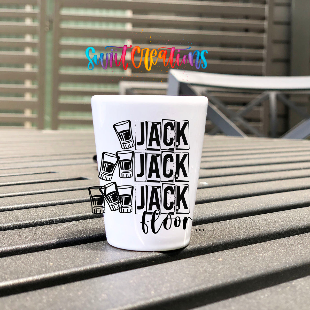 One Jack Two Jack Three Jack Floor UV DTF transfer on a white shot glass on an outdoor patio table