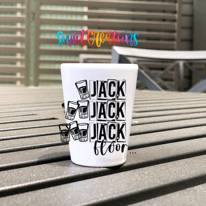One Jack Two Jack Three Jack Floor UV DTF transfer on a white shot glass on an outdoor patio table