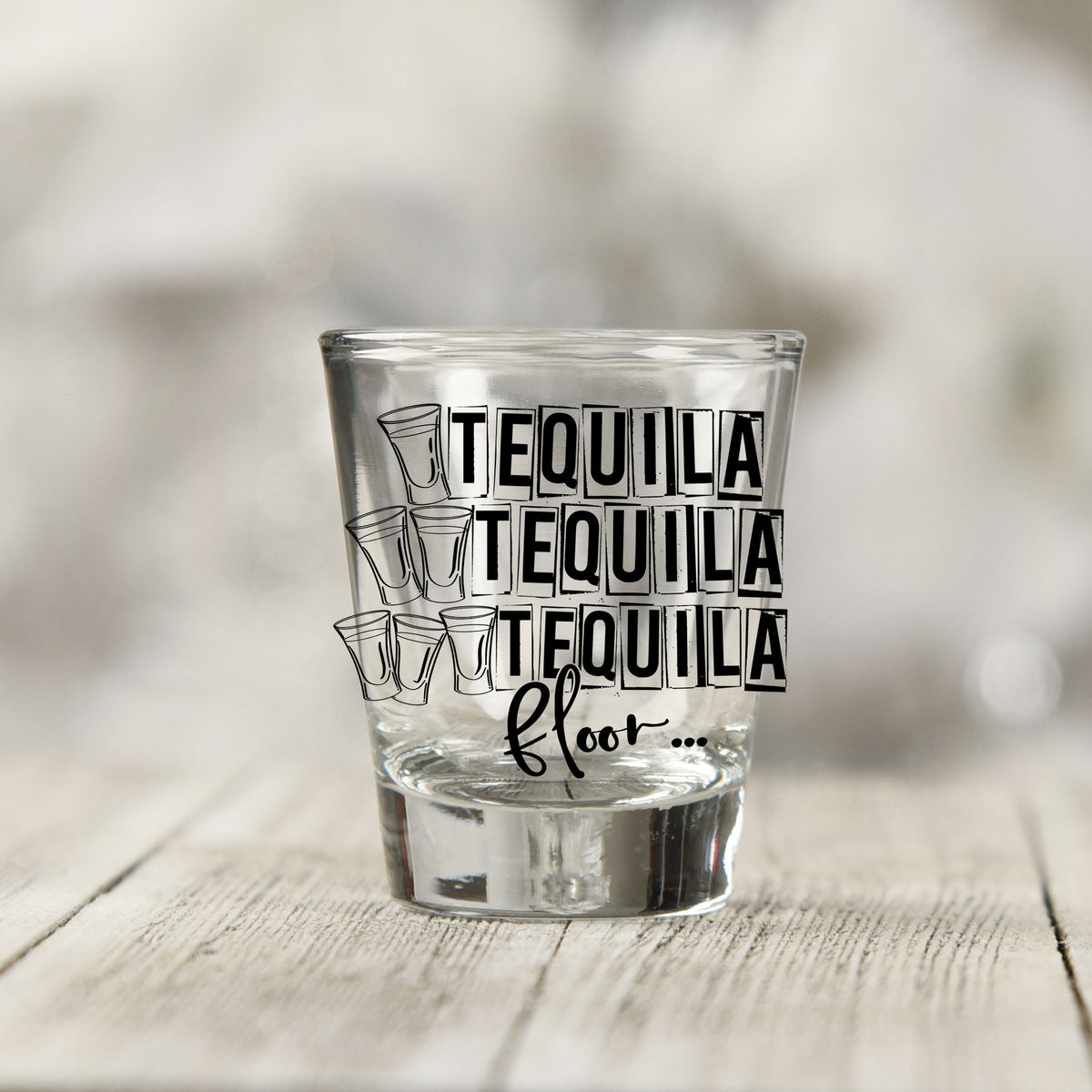 Close-up of the One Tequila Two Tequila Three Tequila Floor UV DTF transfer on a clear shot glass