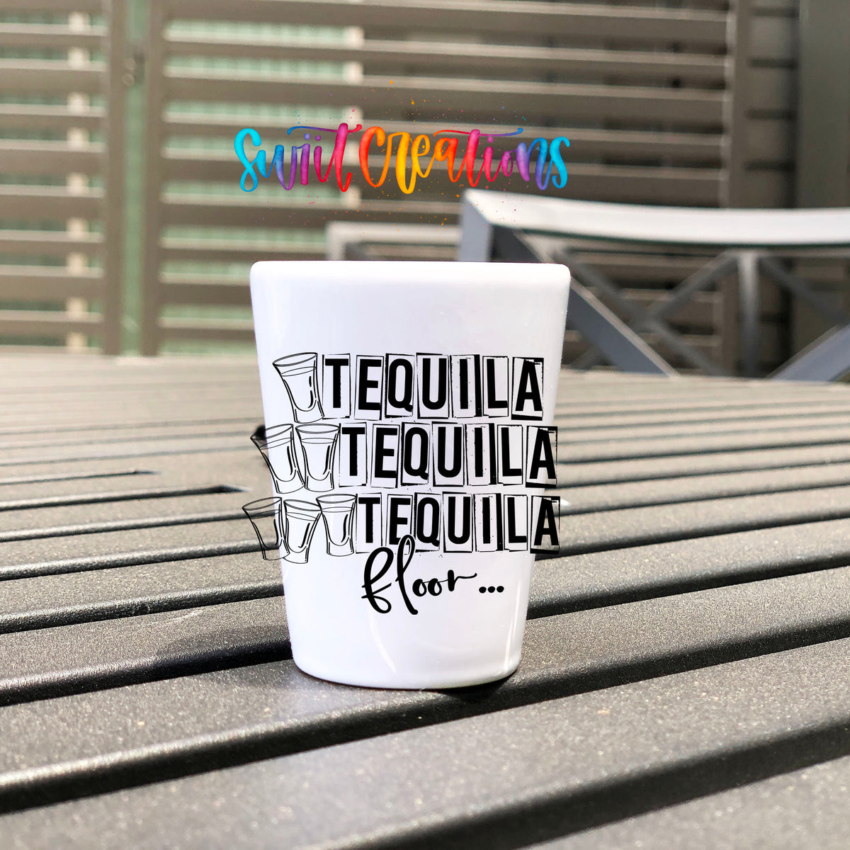 One Tequila Two Tequila Three Tequila Floor UV DTF transfer on a white shot glass on an outdoor patio table