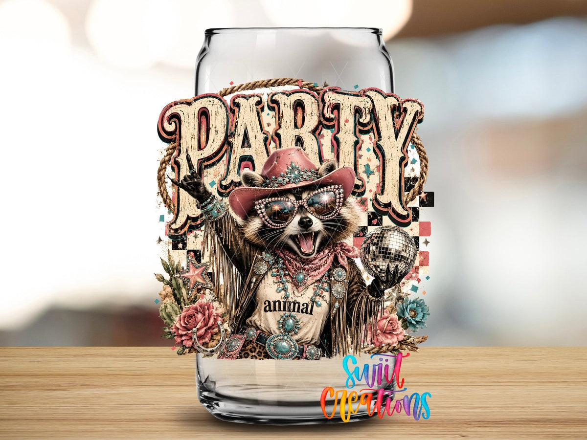 Party Animal Western Glam Raccoon UV DTF transfer applied to a clear glass can from Swiit Creations