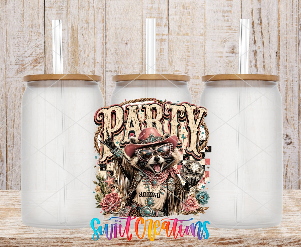 Party Animal Western Glam Raccoon UV DTF transfer applied to a clear glass can set from Swiit Creations