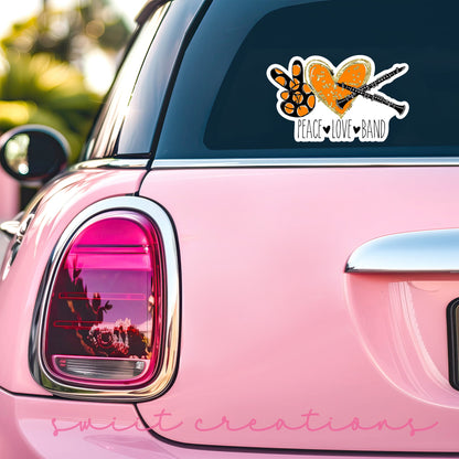 Peace Love Band Clarinet sticker on the back window of a pink car