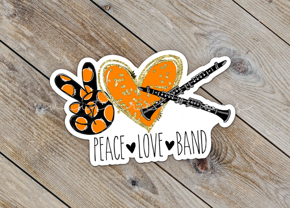 Close-up of the Peace Love Band Clarinet sticker on rustic wood