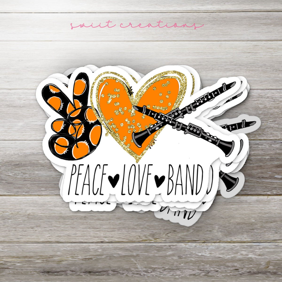 Stack of Peace Love Band Clarinet glossy stickers on a gray wood table