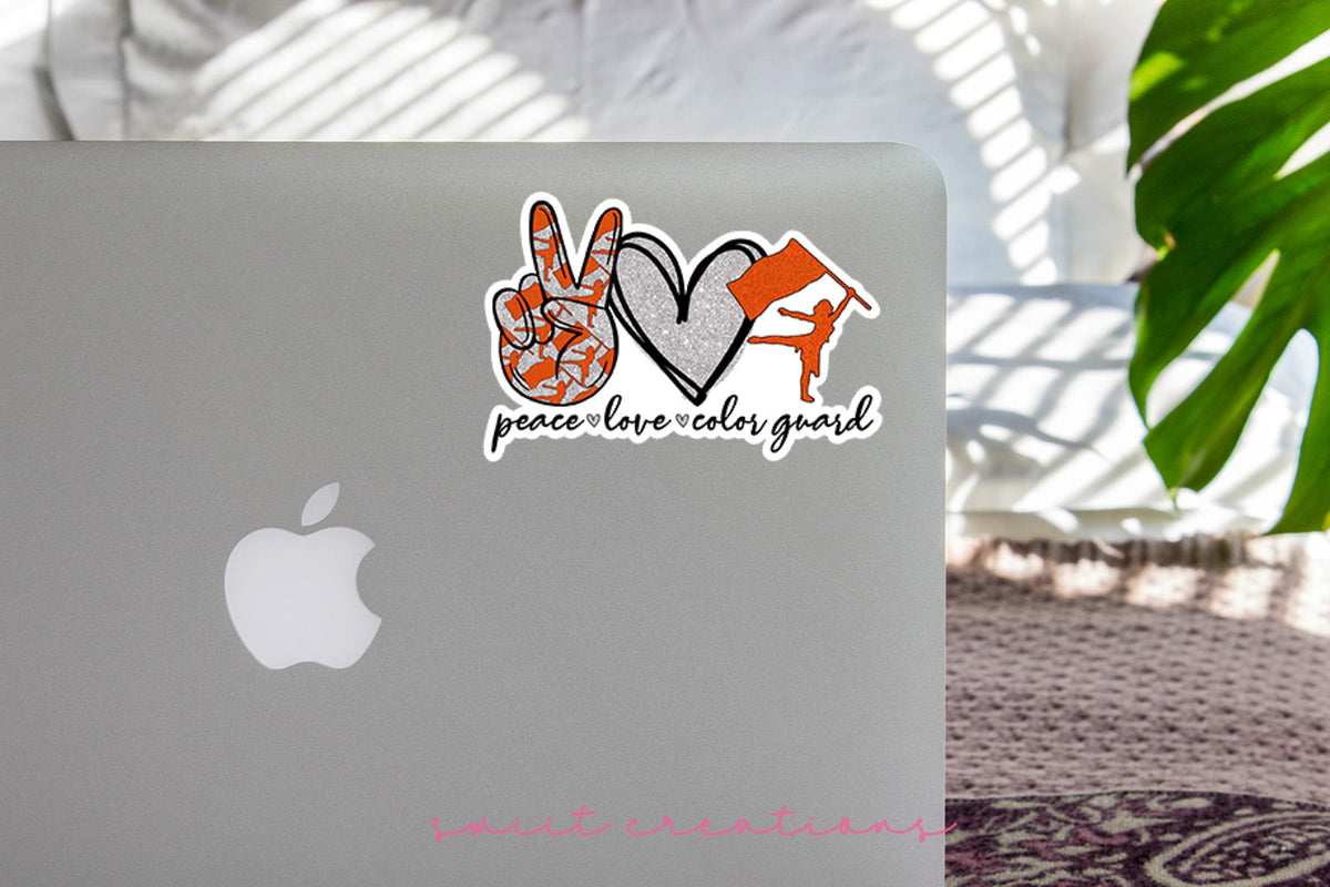 Orange Peace Love Color Guard sticker on the lid of a silver laptop