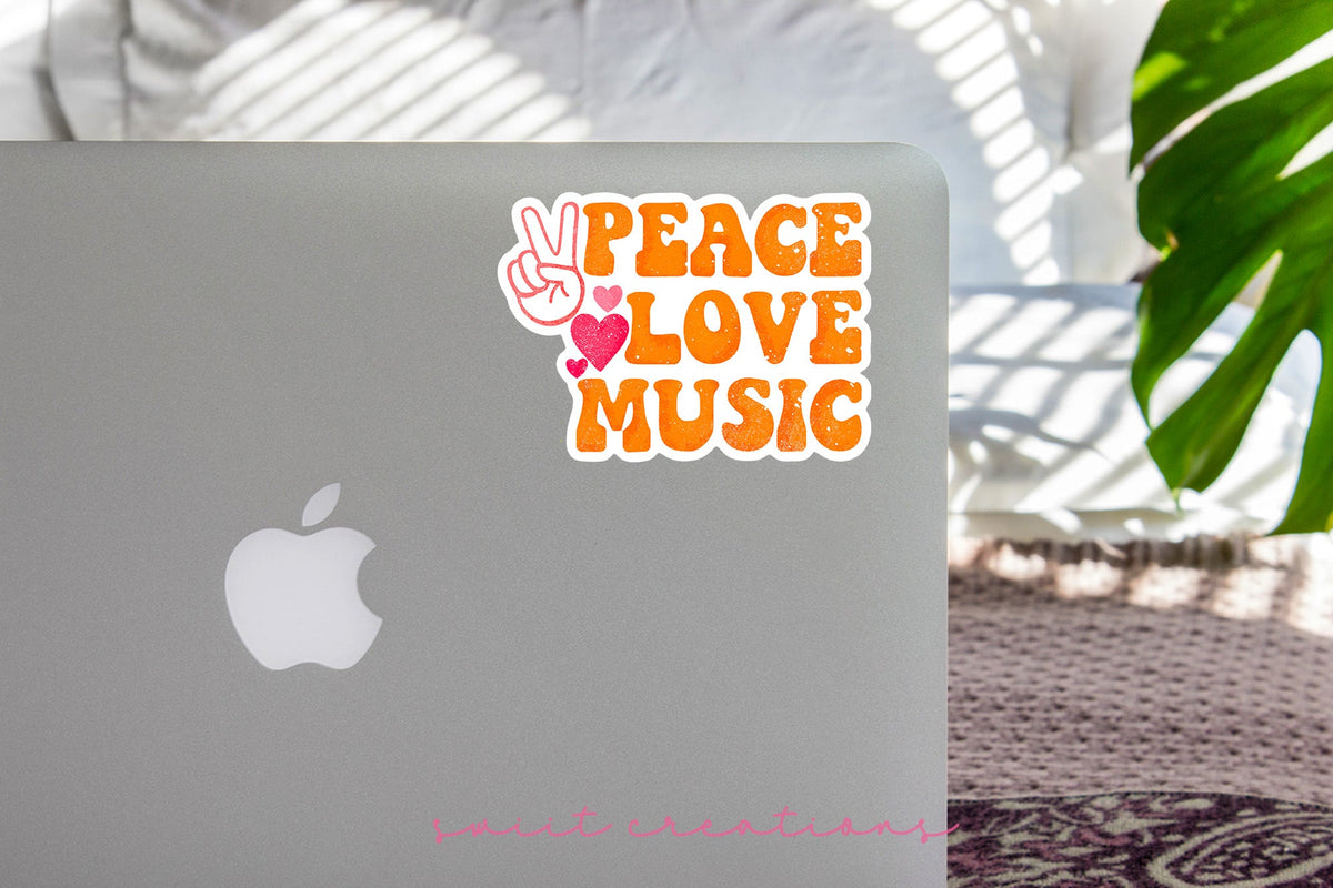 Peace Love Music sticker on the lid of a silver laptop