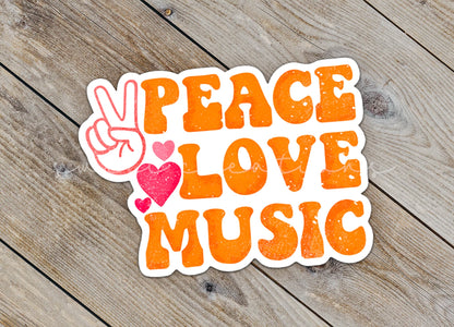Close-up of the Peace Love Music sticker on rustic wood