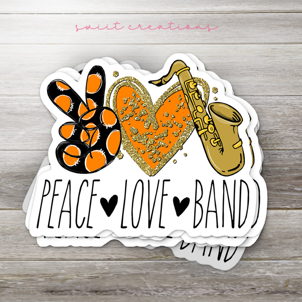 Stack of Peace Love Band Saxophone glossy stickers on a gray wood table