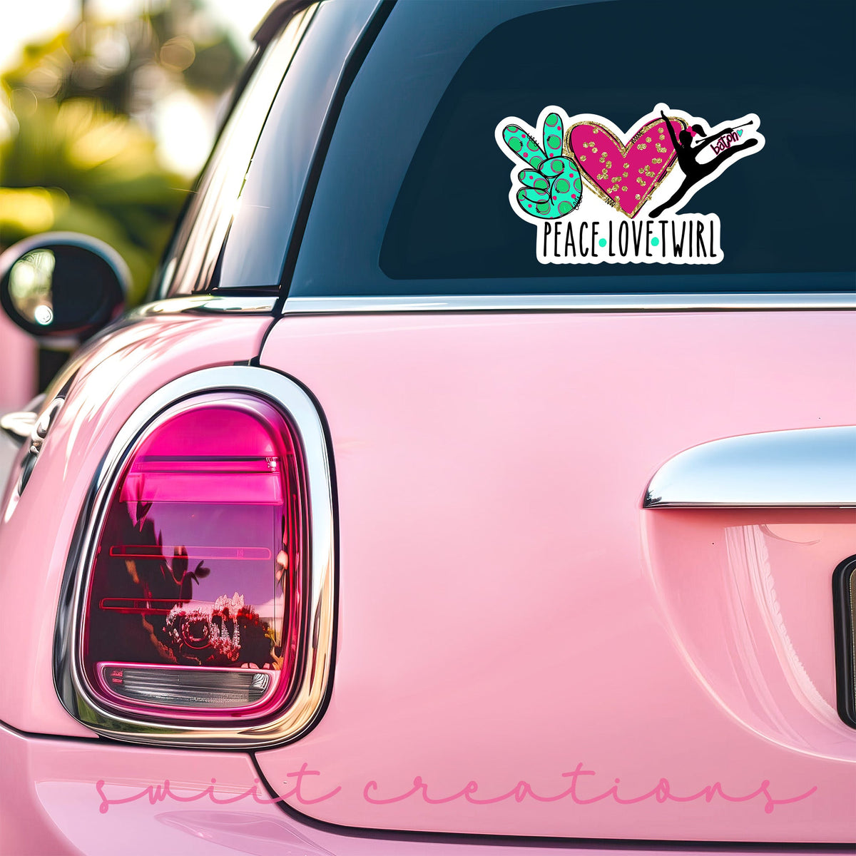 Peace Love Twirl sticker on the back window of a pink car