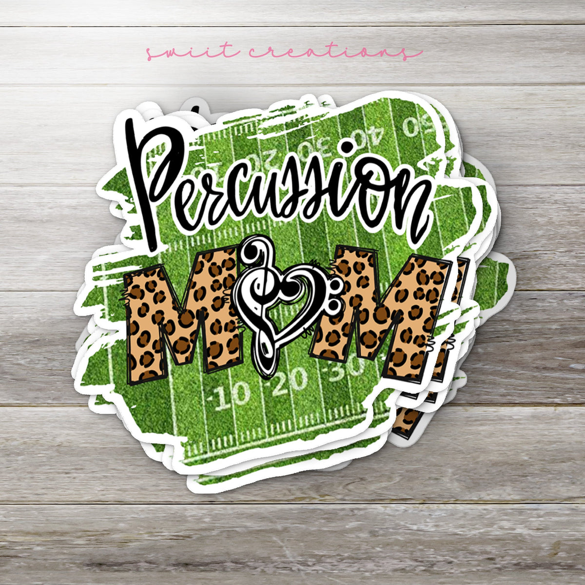 Stack of Percussion Mom glossy stickers on a gray wood table