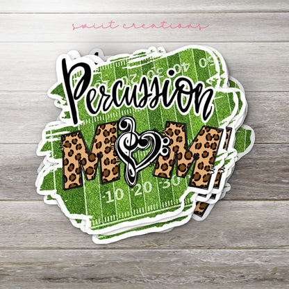 Stack of Percussion Mom glossy stickers on a gray wood table