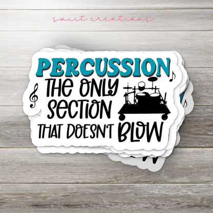 Stack of Percussion Doesn't Blow glossy stickers on a gray wood table