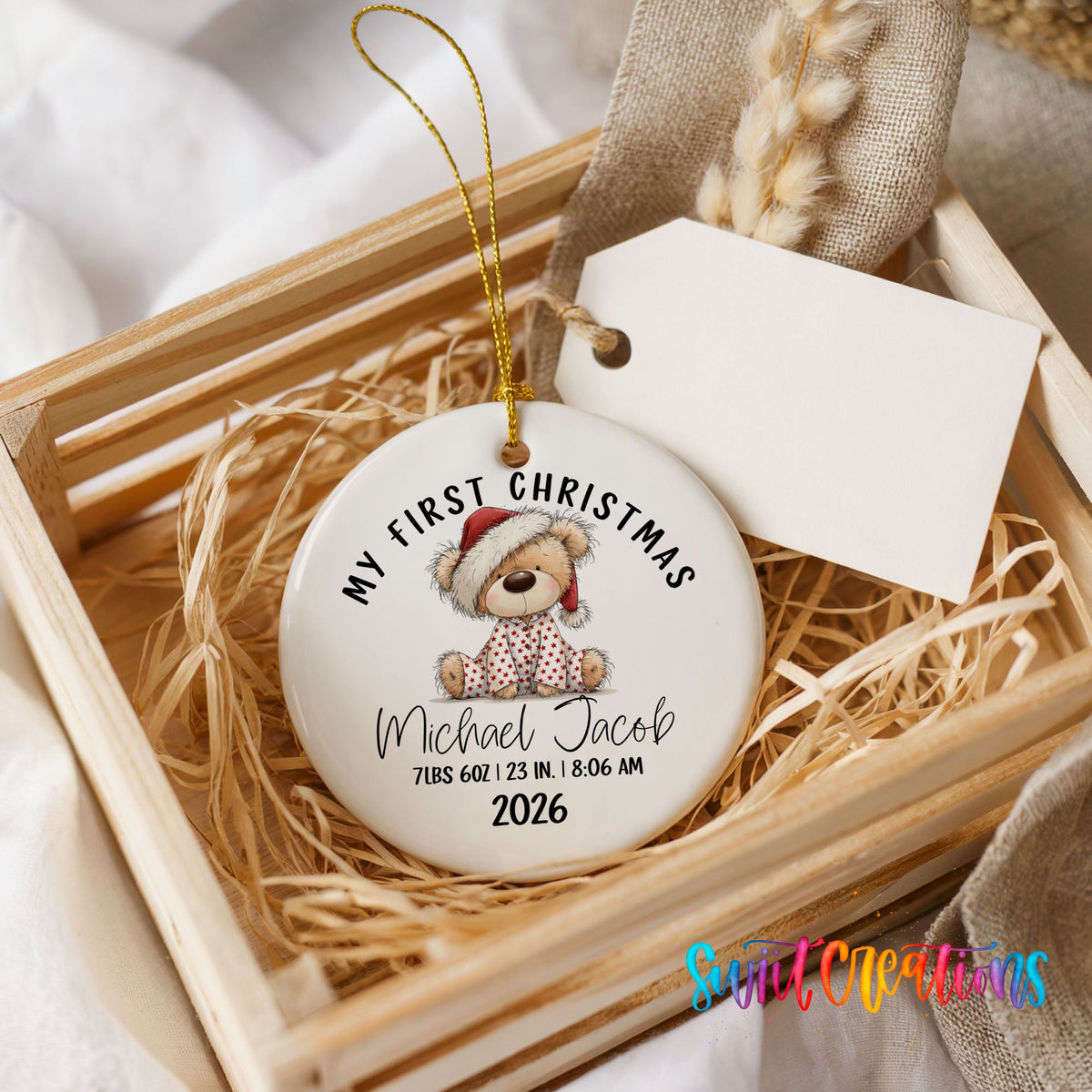 Personalized Baby’s First Christmas Teddy Bear Birth Stats ceramic ornament in a wooden gift crate with straw