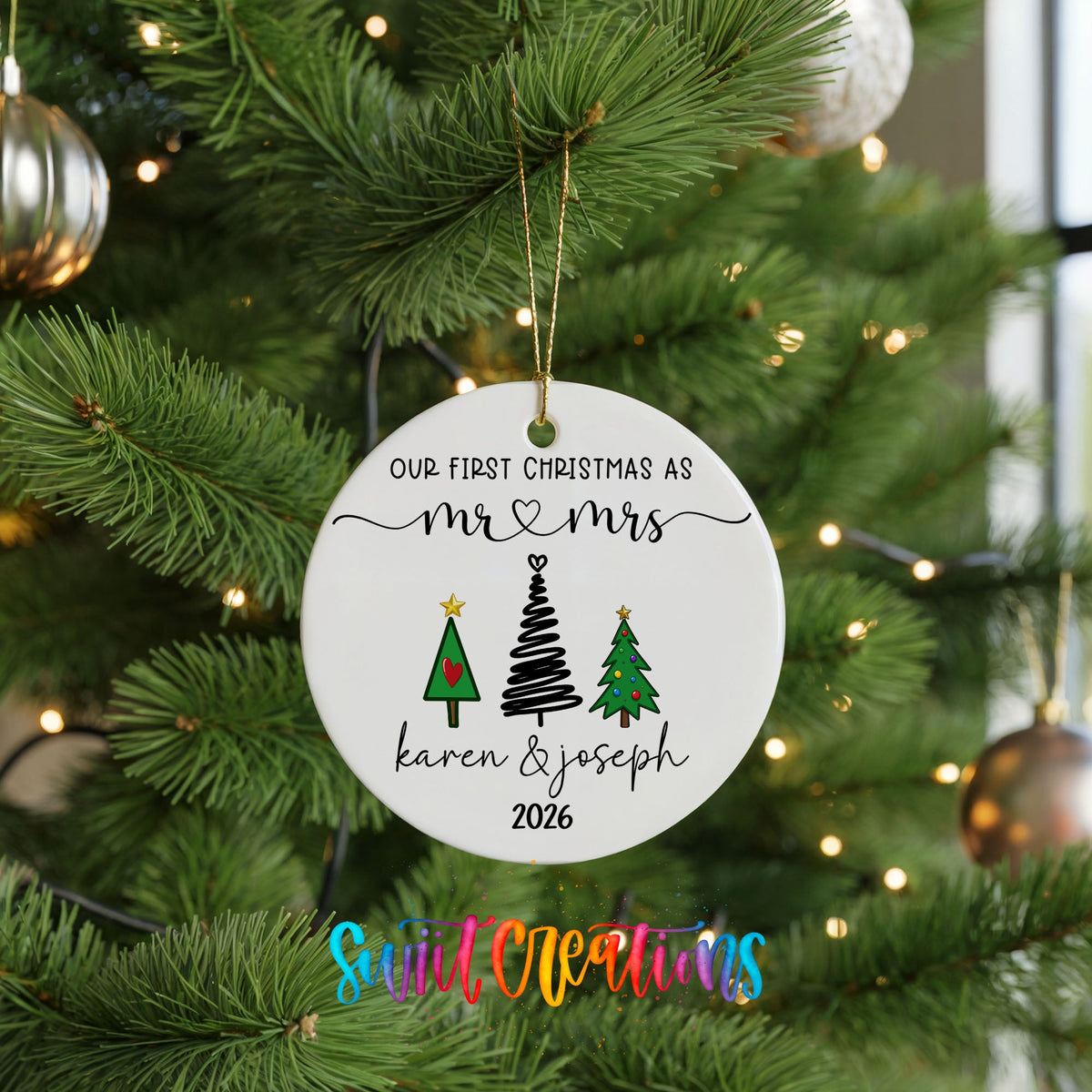 Personalized Our First Christmas Modern Tree Couple ceramic ornament hanging on a lit green Christmas tree