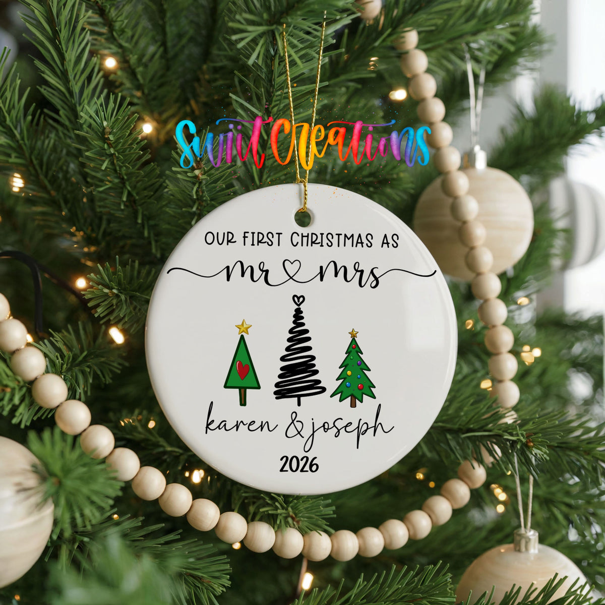 Personalized Our First Christmas Modern Tree Couple ceramic ornament hanging on a Christmas tree with wood bead garland