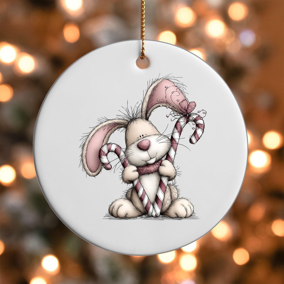 Pink Bunny with Candy Cane ornament UV DTF transfer on a round white ornament with a bokeh light background