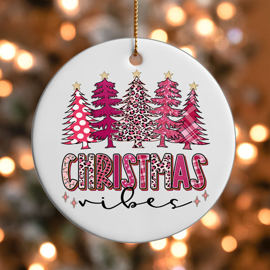 Pink Christmas Vibes Trees ornament UV DTF transfer on a round white ornament with a bokeh light background