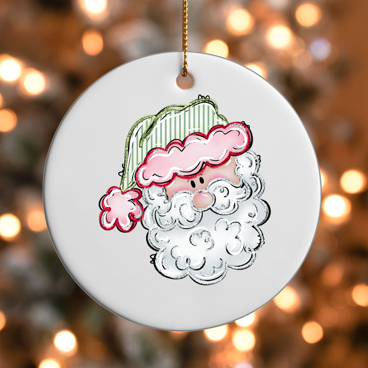Pink Hat Santa ornament UV DTF transfer on a round white ornament with a bokeh light background