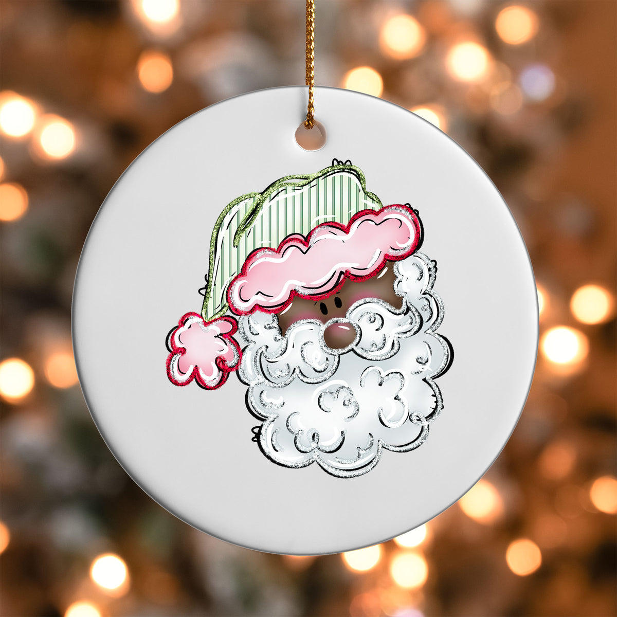 Pink Hat Santa ornament UV DTF transfer on a round white ornament with a bokeh light background