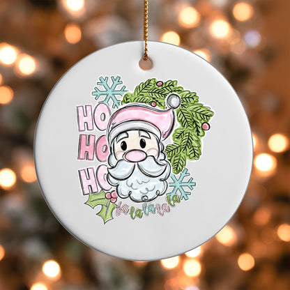 Pink Santa Ho Ho Ho ornament UV DTF transfer on a round white ornament with a bokeh light background