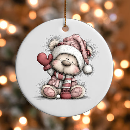 Pink Winter Bear Waving ornament UV DTF transfer on a round white ornament with a bokeh light background