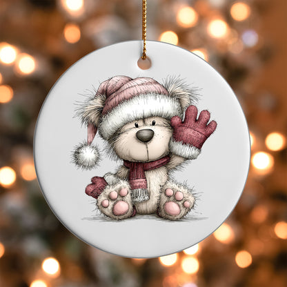 Pink Winter Bear Waving ornament UV DTF transfer on a round white ornament with a bokeh light background