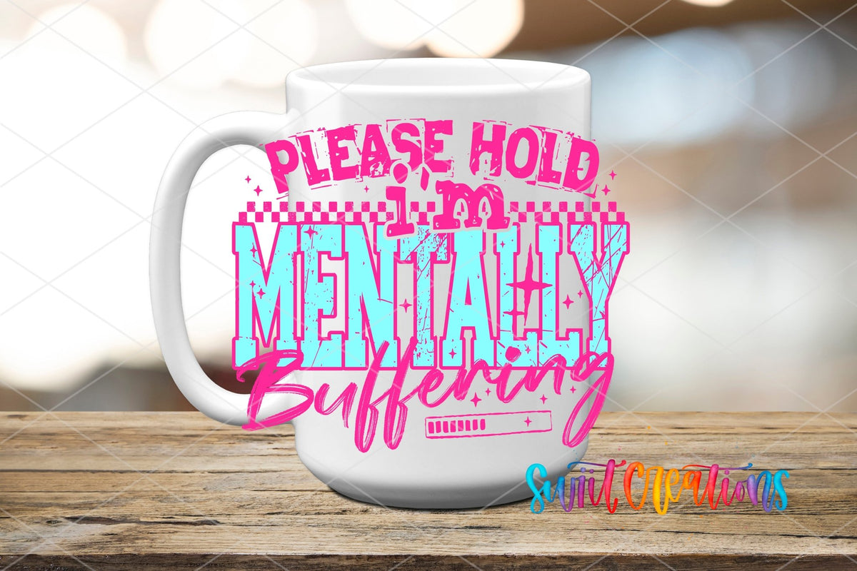 Please Hold I’m Mentally Buffering UV DTF transfer displayed on a white ceramic mug from Swiit Creations