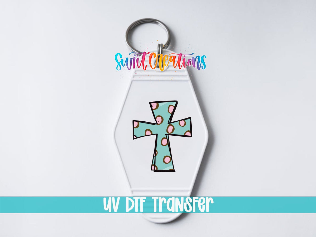 Polka Dot Cross UV DTF transfer on a white motel keychain on a white background