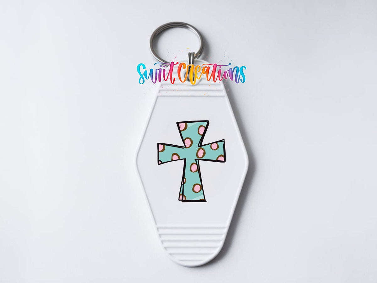Close-up of the Polka Dot Cross UV DTF transfer on a white motel keychain