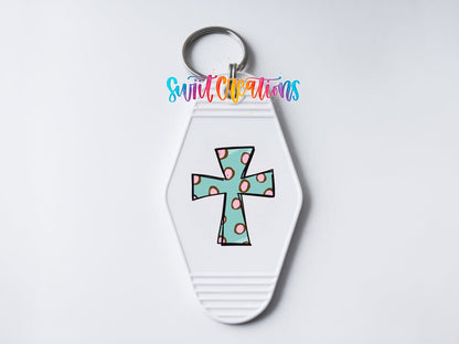 Close-up of the Polka Dot Cross UV DTF transfer on a white motel keychain