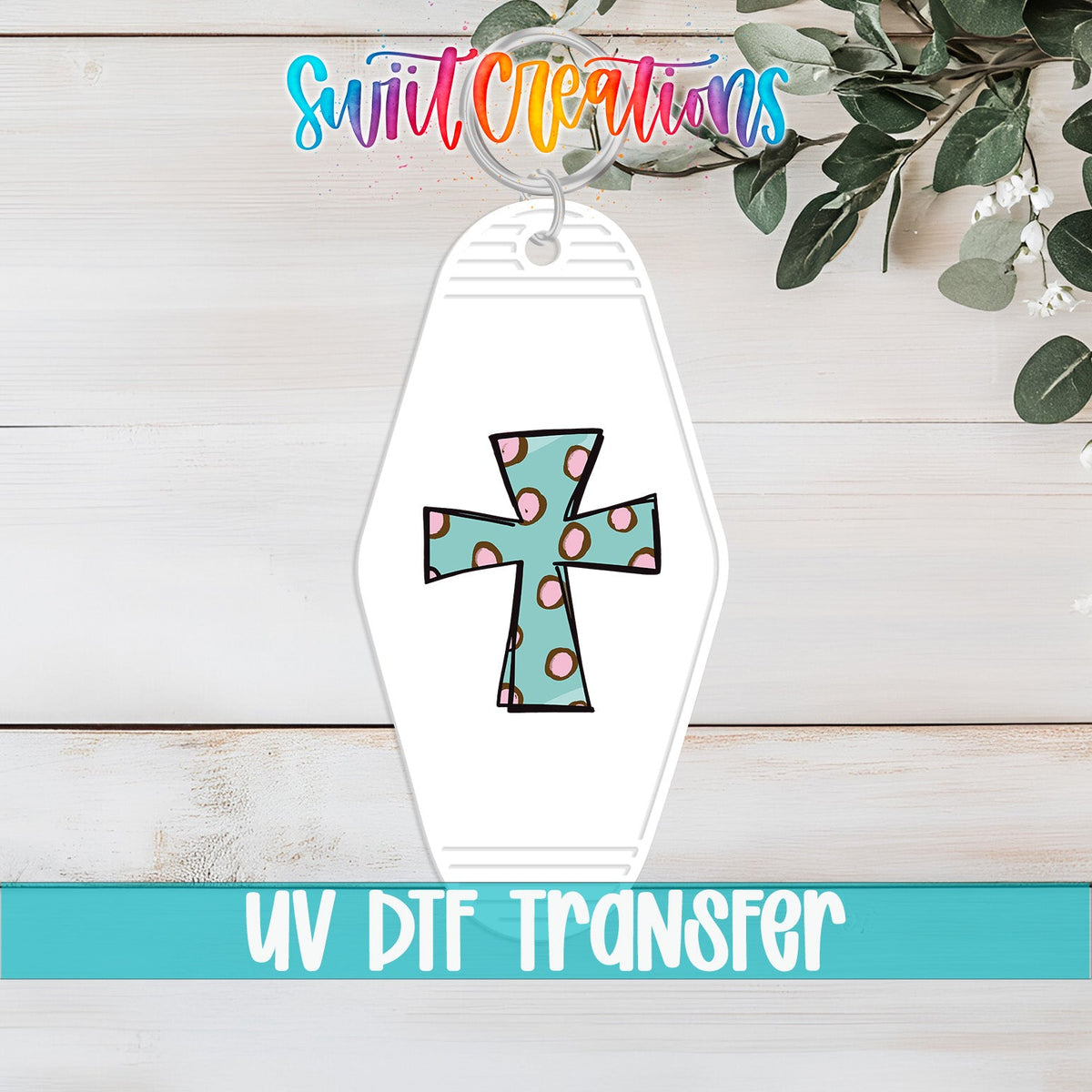 Polka Dot Cross UV DTF transfer on a white motel keychain on a white wood table