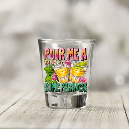 Close-up of the Pour Me a Shot of Some Paradise UV DTF transfer on a clear shot glass