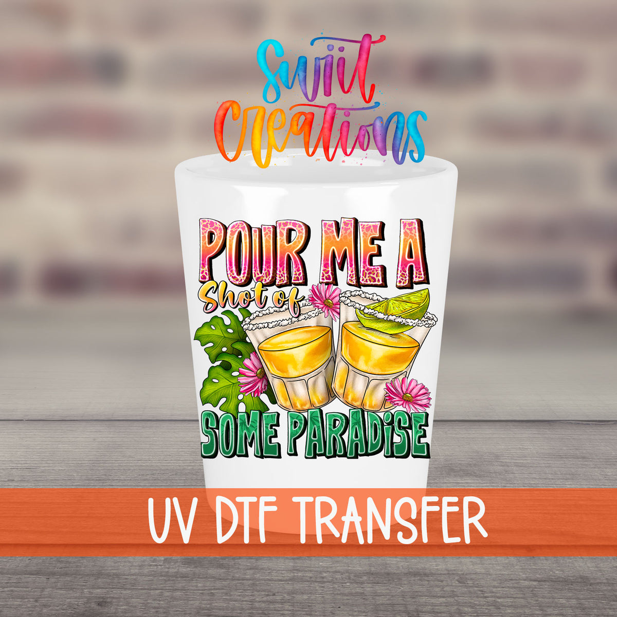 Pour Me a Shot of Some Paradise UV DTF transfer on a white shot glass in front of a brick wall