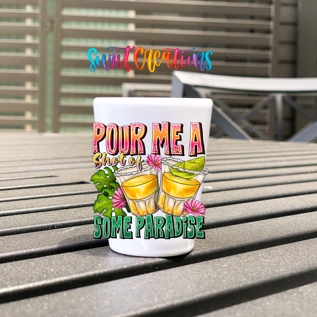 Pour Me a Shot of Some Paradise UV DTF transfer on a white shot glass on an outdoor patio table